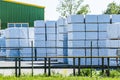 Finished goods warehouse in the open air. Pallets boxes are covered with white film