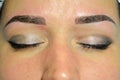 The finished result of microblading, dark eyebrows, permanent makeup on the eyebrows