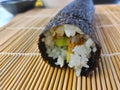 Finished roll of sushi just right before it will be cut to slices