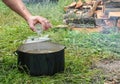 Cooking fish soup in the fresh air