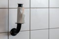 Finished toilet paper - Empty roll of toilet paper mounted on a tiled wall Royalty Free Stock Photo