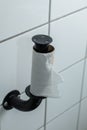 Finished toilet paper - Empty roll of toilet paper mounted on a tiled wall Royalty Free Stock Photo