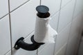 Finished toilet paper - Empty roll of toilet paper mounted on a tiled wall Royalty Free Stock Photo