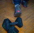 Finished training with weights. Men`s sports footwear for exercise, walking or running, and 5 kg dumbbells