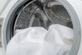 Finishing a part house, washing the white towels.Closeup of washing machine drum