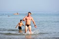 Muscat, Oman June 20th 2018 Father and son swimming in the sea