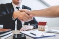 Finishing to successful deal of real estate, Broker and client shaking hands after signing contract approved application form, Royalty Free Stock Photo