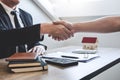 Finishing to successful deal of real estate, Broker and client shaking hands after signing contract approved application form, Royalty Free Stock Photo