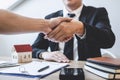 Finishing to successful deal of real estate, Broker and client shaking hands after signing contract approved application form, Royalty Free Stock Photo