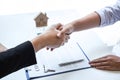 Finishing to successful deal of real estate, Broker and client shaking hands after signing contract approved application form, Royalty Free Stock Photo