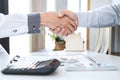 Finishing to successful deal of real estate, Broker and client shaking hands after signing contract approved application form, Royalty Free Stock Photo