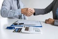 Finishing up of conversation, Realtor agent manager shaking hands with woman client after signing rental form contract agreement, Royalty Free Stock Photo