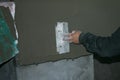 Building. Finishing work. Plasterer work. The hand of the master is rubbing the plaster solution