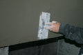 Building. Finishing work. Plasterer work. The hand of the master is rubbing the plaster solution