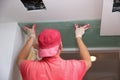 Filling walls and assembly and gluing gypsum boards during renovation of a room.