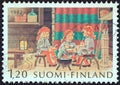 FINLAND - CIRCA 1982: A stamp printed in Finland shows a group of young Christmas elves eating Christmas porridge, circa 1982.