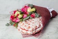 Finland, Espoo. March 6, 2021 Beautiful bouquet of roses and Rafaello sweets.Delicious dessert Royalty Free Stock Photo