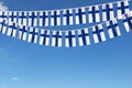 Finland flag festive bunting hanging against a blue sky. 3D Render