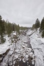 Finland Imatra River canyon cliffs and pine trees in winter Royalty Free Stock Photo