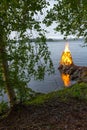 Finland midsummer bonfire through the trees