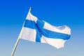 Finland national flag waving on the wind against clear blue sky. Finnish flag on flagpole Royalty Free Stock Photo