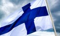 Finland national flag waving in the wind on a cloudy sky Royalty Free Stock Photo