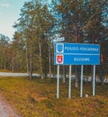 Northern Finland, road sign telling of entering Pohjois-Pohjanmaa and Kuusamo Royalty Free Stock Photo