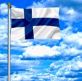 Finland waving flag against blue sky Royalty Free Stock Photo