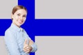 Finland. Young happy cute girl with thumb up against the Finnish flag background. Student or busines concept Royalty Free Stock Photo