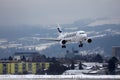 Finnair jet landing on Innsbruck Airport INN, snow in winter
