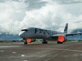 Finnair plane on the runway against the background of the cloudy sky. Vantaa, Finland.