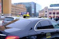 Finnish car with sign Taxi waits for passengers on street of Helsinki city, public transport concept used to transport passengers