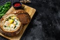 Finnish Creamy fish soup with salmon, trout, potatoes served in bread. Black background, top view, space for text