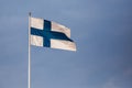 Finnish flag against the blue sunny sky Royalty Free Stock Photo