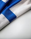 Finnish flag draped elegantly on a flat surface in an indoor setting Royalty Free Stock Photo