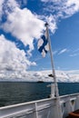 A Finnish flag waving against the blue sky on a ship. Royalty Free Stock Photo