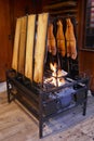 Finnish flame salmon on wooden boards in a wrought iron grill at the open charcoal fire Royalty Free Stock Photo