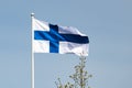 Finnish national flag on the wind against the blue sky Royalty Free Stock Photo