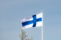 Finnish national flag on the wind against the blue sky Royalty Free Stock Photo