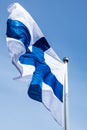 Finnish national flag on the wind against the blue sky Royalty Free Stock Photo