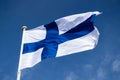 Finnish national flag on the wind against the blue sky Royalty Free Stock Photo