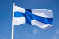 Finnish national flag on the wind against the blue sky Royalty Free Stock Photo