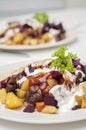 Finnish potato hash with mushroom, beefroot and carrot. Vegetarian diced panfried food with mayonnaise, ketchup and parsley on top Royalty Free Stock Photo