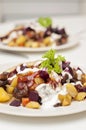 Finnish potato hash with mushroom, beefroot and carrot. Vegetarian diced panfried food with mayonnaise, ketchup and parsley on top Royalty Free Stock Photo