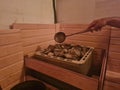 Finnish spa sauna and hot steam water on rocks Royalty Free Stock Photo