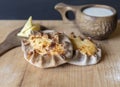 Finnish Traditional Pasties - Karelian Pies From Region Of Karelia. Table with a wooden mug kuksa full of milk Royalty Free Stock Photo