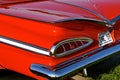 Fins of an old restored red 1959 Chevy