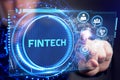 Fintech -financial technology concept.Young businessman select the icon Fintech on the virtual display