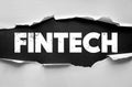Fintech word in rough font under torn paper. Financial technology theme showing innovation, banking evolution, startups, and Royalty Free Stock Photo