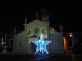 Fiorano al Serio, Bergamo, Italy. The main church of Saint Giorgio with a big illuminated Christmas star during the Christmas time Royalty Free Stock Photo